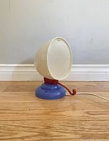 Front angle of the vintage IKEA Smyg lamp showing off-white dome shade atop colorful base.