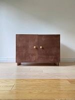 Front view of the cabinet showing two doors and square wooden knobs.