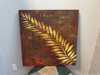 Frontal view of the large square abstract leaf painting on canvas. Shows texture, colors, and leaf detail.