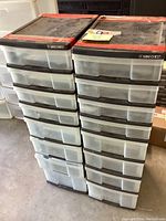 Photo of two black plastic storage units side by side, each with 10 clear drawers and red top edges, dusty and used condition.