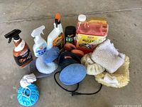 Photo showing overall contents of the car detailing lot from above on concrete floor.