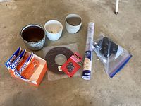 Photo showing multiple garden and home improvement items including ceramic pots, cage glides, ant bait boxes, trim tape and pastry mat.