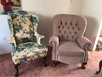 Front view of both chairs showing floral wing chair and pink tufted La-Z-Boy recliner