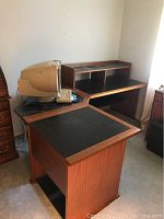L shaped modular three piece computer desk with vintage CRT monitor on the corner piece.