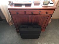 Wooden office cabinet with all contents visible on top and briefcase in front