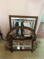 Overview photo showing the oval mirror with floral wooden frame, the square stained glass mirror behind it, and the framed The Last Supper print in front.