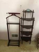 Wide view of both furniture pieces showing valet stand with hanger and multi-tier shelf side-by-side