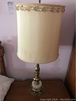 Photo of the lamp fully assembled with fabric shade and trimmed top edge, showing approximate size and style