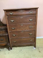 Full front view of the five-drawer oak dresser showing brass handles and keyholes on each drawer.