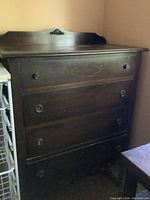 Full frontal image of the dresser showing drawer handles, wood grain, and overall structure.