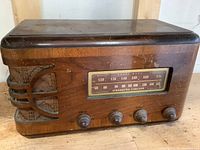Full front view of vintage Stromberg Carlson radio showing wood cabinet, control knobs, tuning dial, and speaker grille.