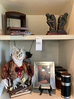 Overview of lot showing owl statue, pen case, framed TV Guide cover, canisters, and bookends
