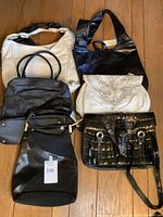 Overhead view of all six handbags arranged on wooden floor