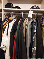 Rack view showing all garments hung on metal rod, various colors.