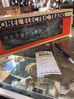 Lionel Electric Train Diner Car in original box labeled Baltimore and Ohio, with clear window showing the interior and silhouettes inside, alongside seller's lot note and pen for scale.