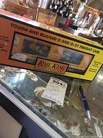 Photo of the boxed goldfish themed O gauge train car showing the front and top of box with product details and price tag.