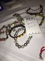 Photo showing seven different stretchy bracelets of varying colors and bead types.