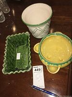 Top view of three vintage ceramic planters in green, yellow, and white with various textures, designs and colors.