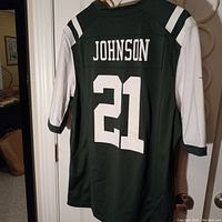 Back view of NFL New York Jets jersey with 'Johnson' and number '21' printed in white on dark green fabric with white sleeves.