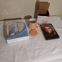 Photo showing three main items: Clinique Sensitive Skin Kit in box, pink ceramic mug with lid, Deepak Chopra meditation CD