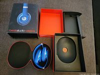 Opened Beats Studio Wireless retail box with headphones in carrying case inside.