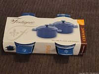Packaging showing two blue ceramic mini Dutch ovens by Fontignac with lids, marked new.