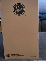 Original cardboard box featuring Hoover logo and product name Floormate Steamscrub 2-in-1