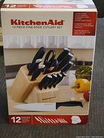 Front of the KitchenAid 12 piece cutlery set box showing image of knives in block and features