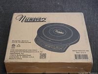 Closed cardboard box of the Nuwave 2 induction cooktop showing product name, model number 30151C, and U.S. design/development info.