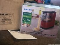 Photo of the Philips Viva Collection pasta maker box showing product image and branding with pasta extruding from machine.
