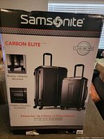 Box front showing Samsonite Carbon Elite 2-piece spinner luggage set, 20-inch and 28-inch, with product features and 10-year warranty logo.