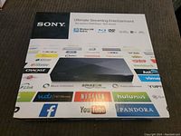 Box front showing Sony Blu-ray Disc/DVD player BDP-BX320 with streaming entertainment apps and wireless LAN built-in icons.