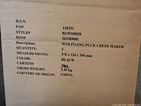 Photo of box label showing product details including brand, model, color, size, and weight.