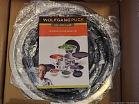 Photo showing the mixing bowls set wrapped in plastic with the use and care booklet on top, displaying the brand and set quantity.