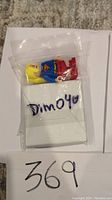 Lego Supergirl minifigure in plastic bag labeled Dim040, shown from the side with clear item visualization