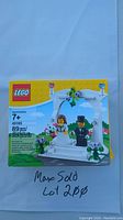 Front image of the boxed Lego 40165 Wedding Cake Topper set with minifigures and floral arch shown.