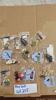 Ten Lego Star Wars minifigures in sealed plastic bags on cardboard background