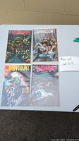 All four Body Count TMNT comic books displayed on a table, each bagged and boarded.