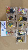 Nine LEGO Series 17 minifigures individually bagged, displayed on cardboard.