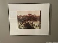 Framed black and white photo of Prague's Saint Charles Bridge shown front-on, includes the photo in mat and black frame.