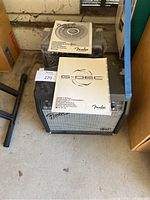 Fender amplifiers with manuals on top showing G-DEC and DSP Bullet 15 models.