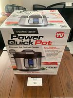 Full boxed unopened Power Quick Pot multi cooker with 6 quart capacity and 1200 watts, showing front box with product image and branding.