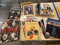 Overview photo showing grouped vintage magazines including Life, Time, and music-themed issues like Led Zeppelin and The Beatles.
