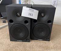 Front view of pair of Yamaha MSP5120V black monitor speakers showing woofer and tweeter with Yamaha logo on the grille.