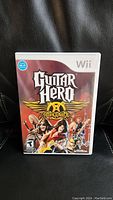 Front cover of Nintendo Wii game Guitar Hero Aerosmith showing title and band artwork.