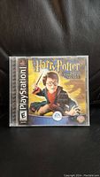 Front view of the Harry Potter and the Chamber of Secrets PlayStation 1 game case showing the cover art featuring Harry Potter with wand.