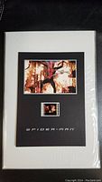 Full view of the Spider-Man cel mounted and matted with film strip segment and title.