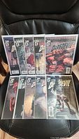 Photo showing front covers of ten Daredevil comic books, arranged on a chair, numbered 40 through 49.
