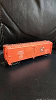 Side view of the red Bachmann Canadian National Railway HO scale box car, showing decals and detail.