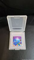 Front view of vintage Tetris game cartridge for Nintendo Game Boy inside its protective case showing colorful label.